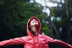 shot of a young girl playing outside in the rain