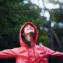 shot of a young girl playing outside in the rain