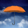 orange umbrella on sky with clouds background