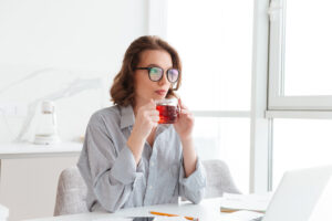 photo of beautiful businesswoman in casual wear drinking hot tea