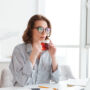 photo of beautiful businesswoman in casual wear drinking hot tea