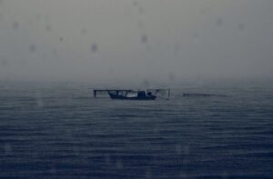 abandoned boat rainy dark sea