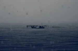 abandoned boat rainy dark sea