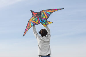 young adult having fun with kite