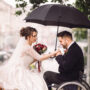 bride and groom on the wheelchair sit kissing on the bench in th