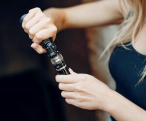 stylish young girl in a city with vape