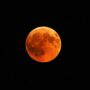 beautiful shot of a red moon, total lunar eclipse with a black night sky in the background