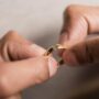 close up hands holding broken ring